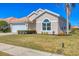 Tan house with tile roof, palm trees, and a two-car garage at 6978 Superior Street Cir, Sarasota, FL 34243