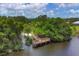 Aerial view showing serene lake access with a wooden dock and walkway at 6978 Superior Street Cir, Sarasota, FL 34243