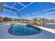 Kidney-shaped pool with screened enclosure and lake view at 6978 Superior Street Cir, Sarasota, FL 34243