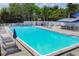 Community pool with plenty of lounge chairs for relaxing at 6978 Superior Street Cir, Sarasota, FL 34243