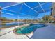 Kidney-shaped pool with a screened enclosure overlooking a lake at 6978 Superior Street Cir, Sarasota, FL 34243