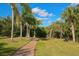 Relaxing walking path with lush landscaping and a bench at 6978 Superior Street Cir, Sarasota, FL 34243