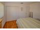 Bedroom with wood floors and striped bedding at 7003 9Th W Ave, Bradenton, FL 34209