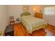 Bedroom with wood floors and striped bedding at 7003 9Th W Ave, Bradenton, FL 34209