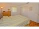 Bedroom with wood floors and striped bedding at 7003 9Th W Ave, Bradenton, FL 34209