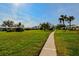 Residential community showcasing a tree-lined street and manicured lawns at 7003 9Th W Ave, Bradenton, FL 34209