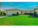 Well-maintained house with a lush lawn and attached garage at 7003 9Th W Ave, Bradenton, FL 34209