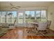 Sunroom with wood flooring, table and chairs, and view of the outdoors at 7003 9Th W Ave, Bradenton, FL 34209