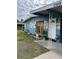 Close up view of the home's entrance, showcasing the unique blue facade and landscaping at 7309 Royal Palm Dr, New Port Richey, FL 34652