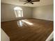 Sunlit bedroom with hardwood floors and ceiling fan at 7337 Cone Shell Dr, Spring Hill, FL 34607