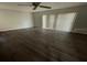 Hardwood floor, bright living room featuring a ceiling fan and sliding glass doors at 7337 Cone Shell Dr, Spring Hill, FL 34607