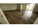 Bright living room featuring sleek wood floors and natural light from sliding glass door at 7337 Cone Shell Dr, Spring Hill, FL 34607