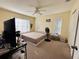 Bedroom with king-size bed and large windows at 7615 River Oak Run # 103, Lakewood Ranch, FL 34202