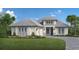 Two-story home with a light gray exterior, gray roof, and landscaping at 8516 Sandpoint St., Sarasota, FL 34231