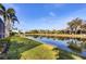 Beautiful backyard featuring lush green grass and serene water views, perfect for outdoor enjoyment at 8729 52Nd E Dr, Bradenton, FL 34211