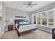 Bright bedroom featuring a large window with views of the screened-in lanai and a ceiling fan at 8729 52Nd E Dr, Bradenton, FL 34211