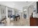 Dining room with table, blue upholstered chairs, chandelier, and view to the kitchen with bar stool seating at 8729 52Nd E Dr, Bradenton, FL 34211