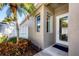 Inviting front entrance with a well-kept garden, neutral tones, and a modern white front door at 8729 52Nd E Dr, Bradenton, FL 34211