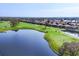 Beautiful golf course view with a lake, manicured greens, and luxury homes in the background at 8729 52Nd E Dr, Bradenton, FL 34211