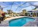 Stunning screened-in pool with inviting outdoor seating, perfect for relaxation and entertaining by the water at 8729 52Nd E Dr, Bradenton, FL 34211