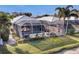 Aerial view of a screened-in pool area with outdoor seating and a well-maintained backyard at 8729 52Nd E Dr, Bradenton, FL 34211