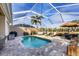 Screened-in pool area offers a relaxing retreat with a pool, patio furniture, and views of the water at 8729 52Nd E Dr, Bradenton, FL 34211