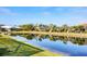 A serene waterfront view behind a row of houses with screened in patios at 8729 52Nd E Dr, Bradenton, FL 34211