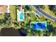 Overhead view of the tennis court and pool at 8755 Olde Hickory Ave # 7302, Sarasota, FL 34238