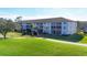 Beautiful lawn with walkway leading to the condo buildings, with screened in lanais at 8755 Olde Hickory Ave # 7302, Sarasota, FL 34238