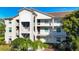 Condo exterior featuring balconies and manicured landscaping at 8755 Olde Hickory Ave # 7302, Sarasota, FL 34238