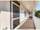 Exterior condo hallway with a screen door and view at 8755 Olde Hickory Ave # 7302, Sarasota, FL 34238