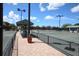 Community tennis courts with shade canopies and well-maintained fencing at 8755 Olde Hickory Ave # 7302, Sarasota, FL 34238