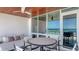 Well-appointed covered balcony features an ocean view, dining set, and outdoor furniture at 1035 Seaside Dr # 503, Sarasota, FL 34242