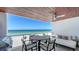 Spacious balcony overlooking the ocean, featuring a dining table and comfortable lounge seating at 1035 Seaside Dr # 503, Sarasota, FL 34242