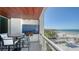 Beautiful balcony with an ocean view, complete with a dining table and an outdoor grill at 1035 Seaside Dr # 503, Sarasota, FL 34242