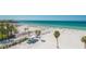 Picturesque view of beach and beautiful water, with palms, shade structure, and beach goers at 1035 Seaside Dr # 503, Sarasota, FL 34242