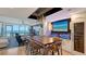 Open dining area with a modern table, custom lighting, and ocean view at 1035 Seaside Dr # 503, Sarasota, FL 34242