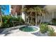 Relaxing outdoor hot tub area surrounded by lush landscaping and manicured gardens at 1035 Seaside Dr # 503, Sarasota, FL 34242