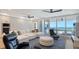 Bright living room featuring a large sectional sofa, floor to ceiling windows, and stunning ocean views at 1035 Seaside Dr # 503, Sarasota, FL 34242