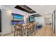 Modern living room featuring a large dining table, wet bar, and ocean views at 1035 Seaside Dr # 503, Sarasota, FL 34242