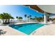 Stunning swimming pool with ocean views and beach access surrounded by palm trees at 1035 Seaside Dr # 503, Sarasota, FL 34242