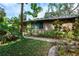 Brick pathway with lush landscaping and tropical plants at 1155 Hampton Rd, Sarasota, FL 34236