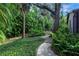 Brick pathway through a garden with tropical plants at 1155 Hampton Rd, Sarasota, FL 34236