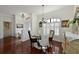 Formal dining room with hardwood floors, a round table, and white shutters at 12823 Penguin Dr, Bradenton, FL 34212