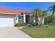 Front view of home showcasing tile roof, landscaping, and two-car garage at 12823 Penguin Dr, Bradenton, FL 34212