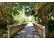 Wooden footbridge leading through lush landscaping at 12823 Penguin Dr, Bradenton, FL 34212