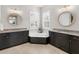 Elegant bathroom with dual vanities, granite countertops, and soaking tub at 13922 Old Creek Ct, Parrish, FL 34219