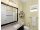 Well-lit bathroom features a granite vanity, decorative shelving, and a shower with white subway tile at 13922 Old Creek Ct, Parrish, FL 34219