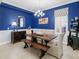 Chic dining room featuring bold blue walls and stylish decor at 13922 Old Creek Ct, Parrish, FL 34219