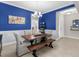 Dining room with blue accent wall and rustic wood table at 13922 Old Creek Ct, Parrish, FL 34219